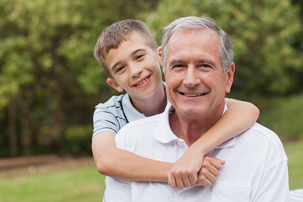 istock Young boy hugging his grandfather 457422499