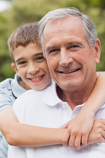 istock Grandfather and his grandson posing together while hugging 457422507