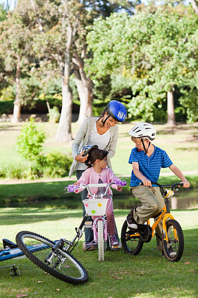 istock Mother puts a helmet on her daughter 457422555