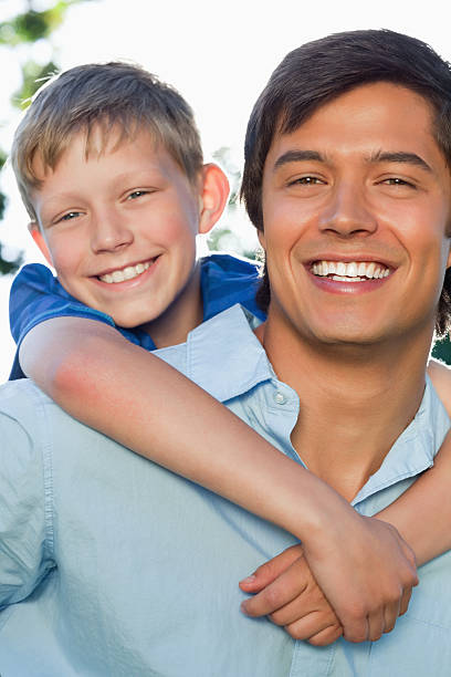 istock Smiling boy with the arms around his father's shoulder 457422961