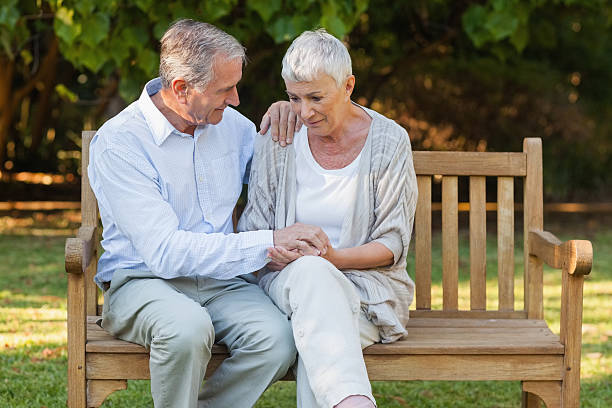 istock Elderly man comforting his wife 457423011
