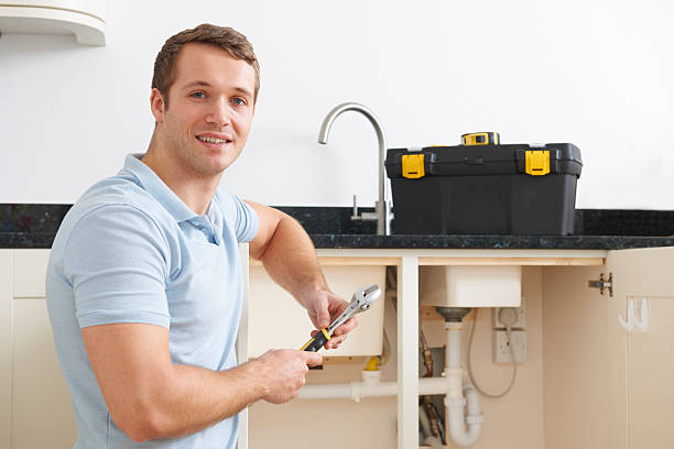 istock Portrait of young plumber fixing kitchen sink 457425381