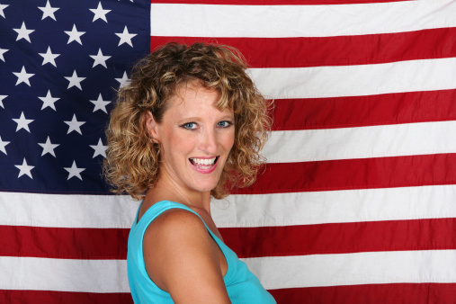 Woman smiles happily on an American flag background