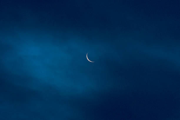 Photo of moon, waning crescent, seen through a thin cloudlayer