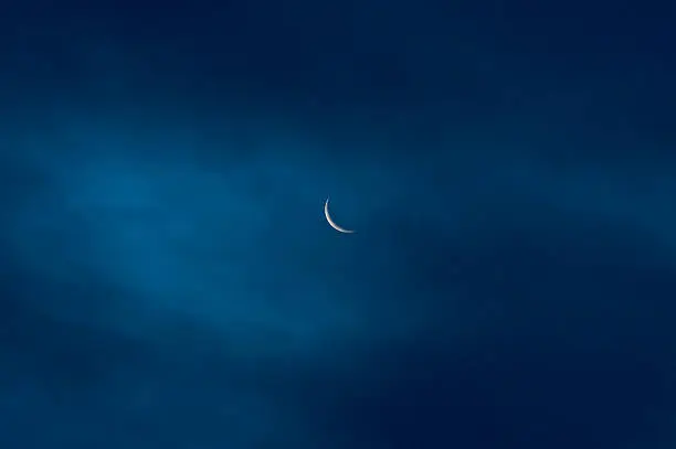 moon, waning crescent, seen through a thin cloudlayer