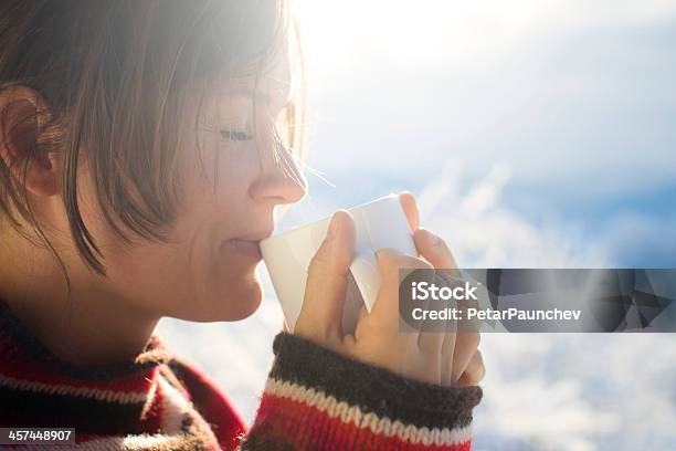 Woman Drinking A Hot Drink While Wearing A Sweater Stock Photo - Download Image Now - Adult, Adults Only, Artist's Model