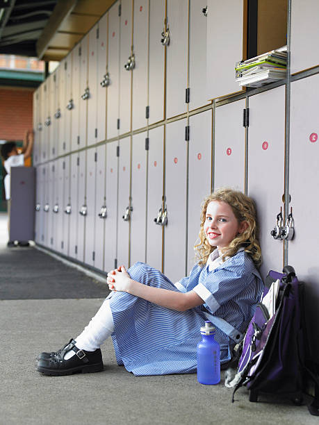 istock Happy Girl Sitting Against School Lockers 457449297