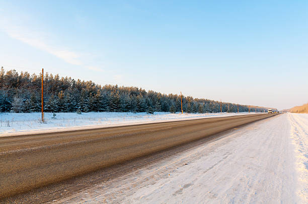 istock Winter road surrounded by snow-covered forest in Siberia 457451987