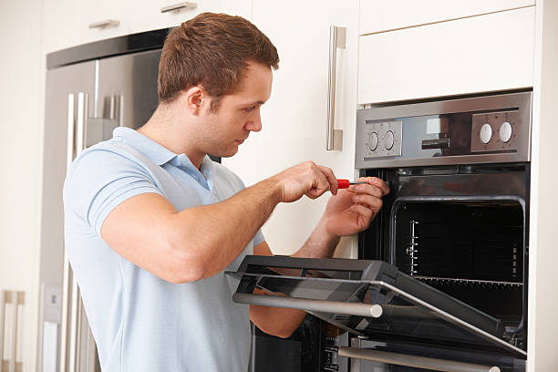 istock Man Repairing Domestic Oven In Kitchen 457482831