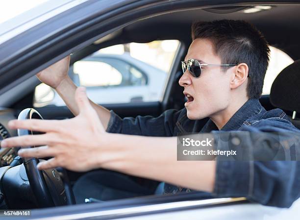 A Driver In Sunglasses Pulling An Irritated Gesture Stock Photo - Download Image Now