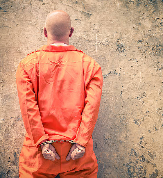 Handcuffed prisioner waiting for death penalty, back view Handcuffed Prisoners waiting for Death Penalty detainee stock pictures, royalty-free photos & images