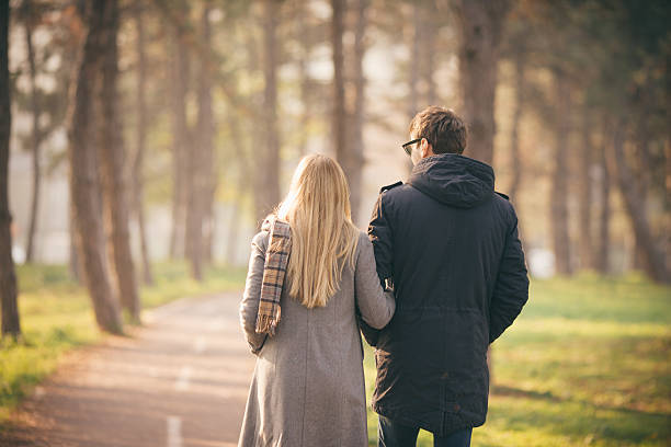 istock Young couple walking in the park 457489083