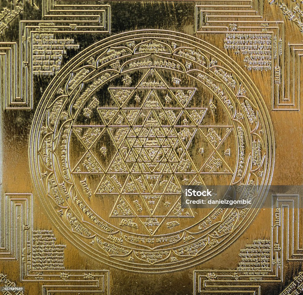 Sri Yantra Macro photo of gold Sri Yantra.  Selective focus. Sacred Geometry Stock Photo