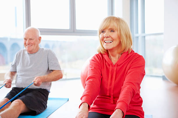 istock Fit senior couple doing exercises with a resistance band 457489849