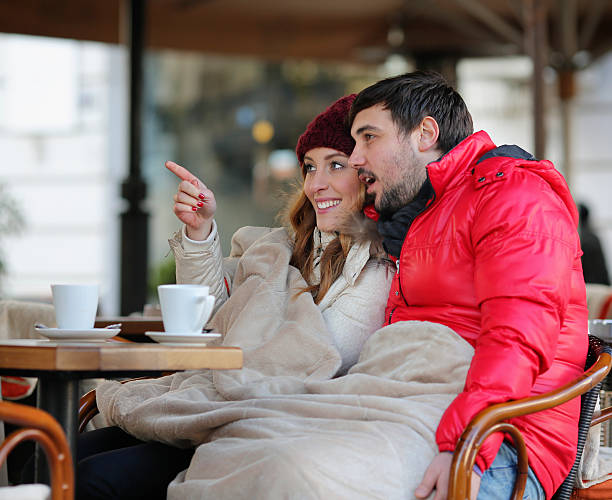 istock Young couple drinking tea in winter outdoors. 457490217