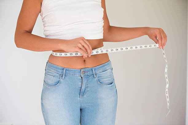 istock Woman Measuring Her Waist 457490501
