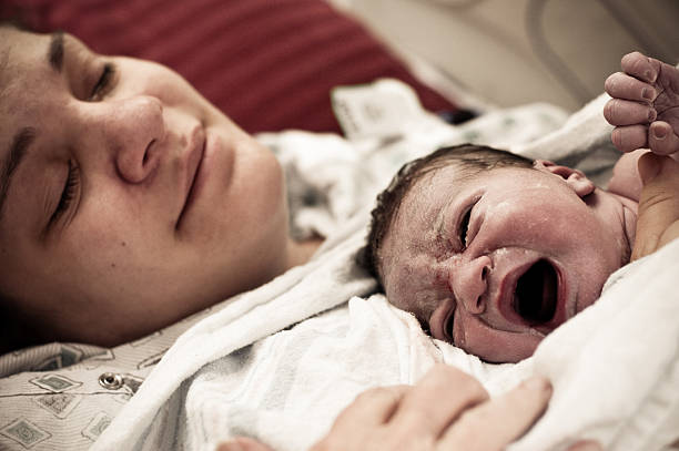 Mother Holding Newborn At The Hospital stock photo