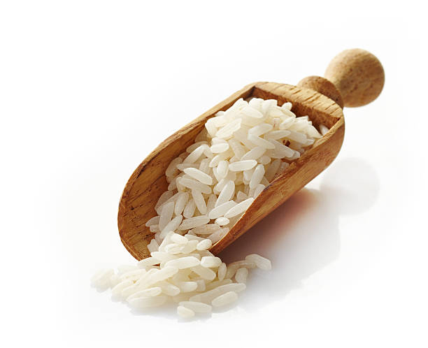 istock wooden scoop with white rice 457511011
