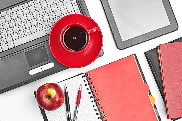 istock Laptop and office supplies on white 457511991