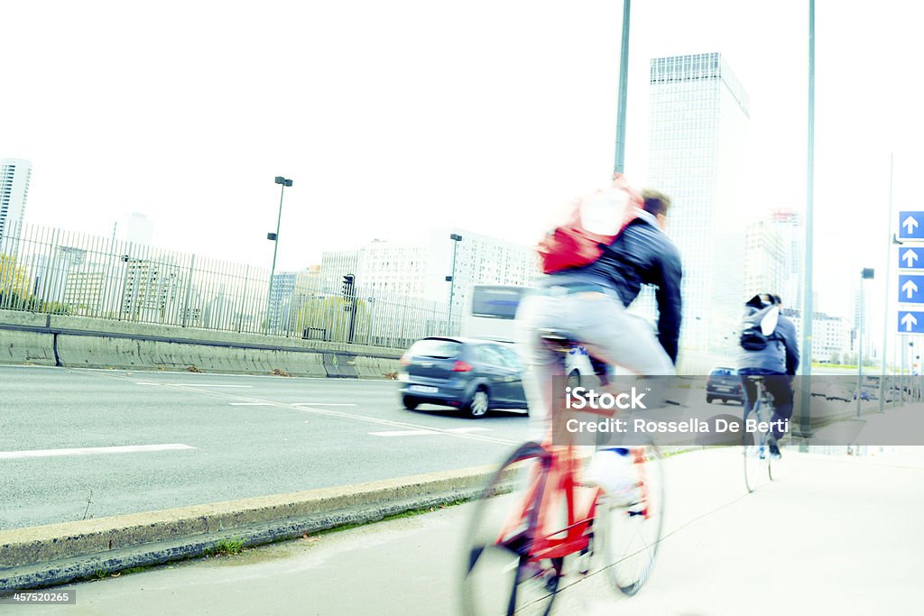 Blur in motion bicyclist commuting to work Bicycles on a street. Blurred motion. Office buildings on the background. Green Economy Stock Photo