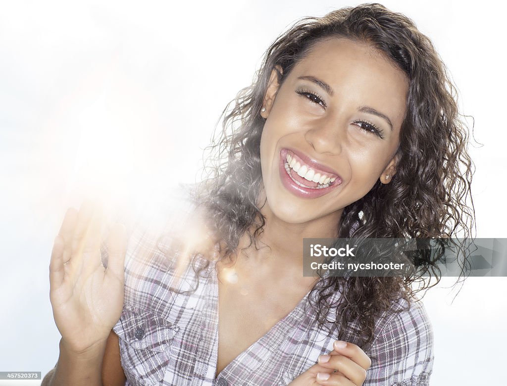 Laughing girl in sunlight Young Hispanic enjoying, laughing with sun in background. 20-29 Years Stock Photo