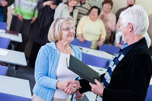 istock Senior woman receiving an award 457520549