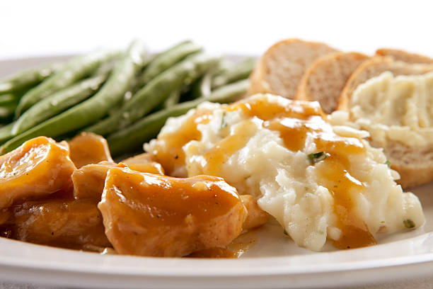 istock Turkey and Gravy Dinner with Mashed Potatoes, Green Beans, Bread 457529203