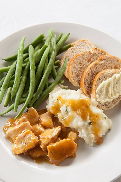 istock Turkey and Gravy Dinner with Mashed Potatoes, Green Beans, Bread 457542435