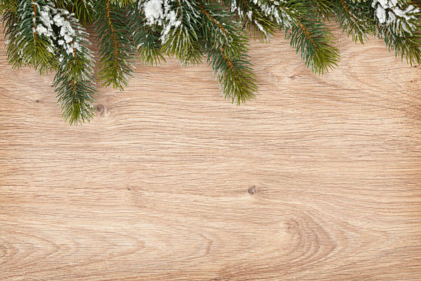 istock Christmas fir tree on wooden board 457550447