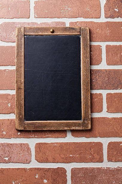 istock Vintage chalk board on red brick wall 457660123