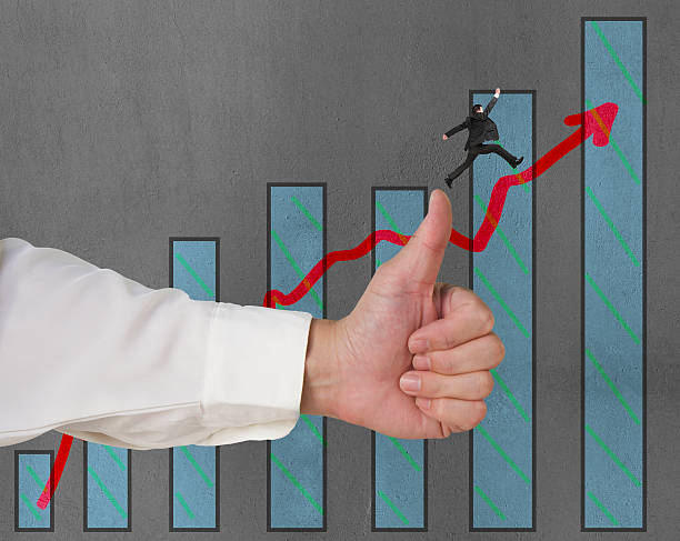 istock Businessman jumping on growing red arrow with thumb up 457677481