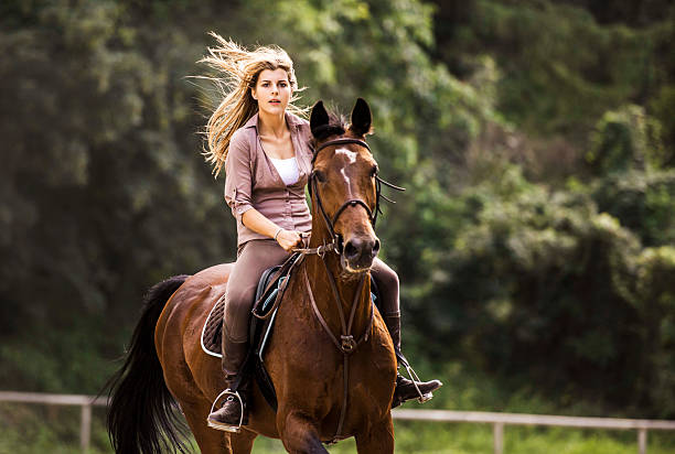 istock Woman horseback riding. 457679047