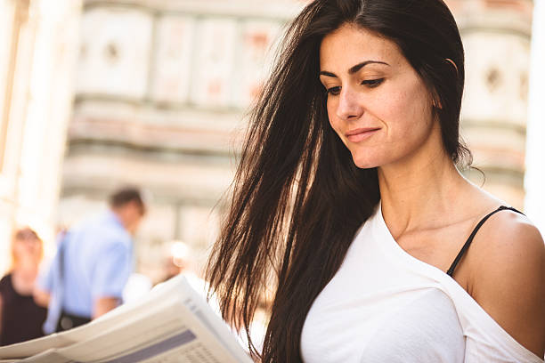 istock Woman reading the newspapers and smiling 457679273