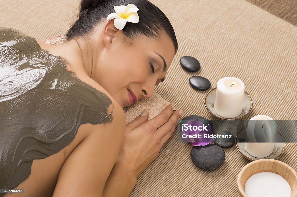 Green Clay Treatment At Spa Relaxed Woman Receiving A Mud Treatment At Spa Facial Mask - Beauty Product Stock Photo