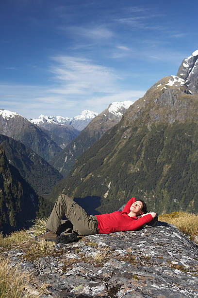 istock Woman Lying On Boulder Against Mountains 457707119