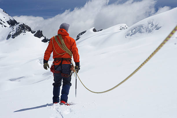 istock Hiker Connected To Safety Line In Snowy Mountains 457707161