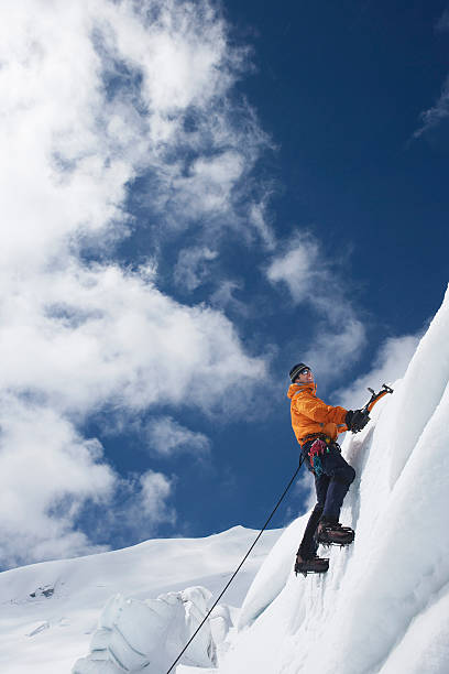 istock Mountain Climber Going Up Snowy Slope With Axes 457707223