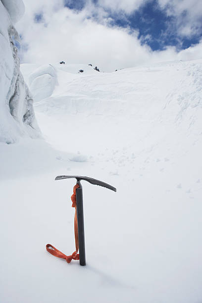 istock Mountain climbing pick axe in the snow 457707559