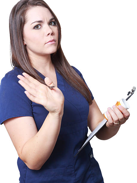 Nurse checking medication and chart sternly stock photo
