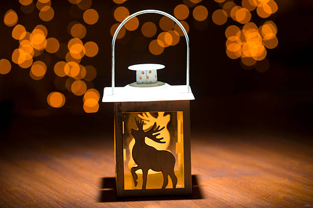 istock christmas candle lamp on wooden 457739993