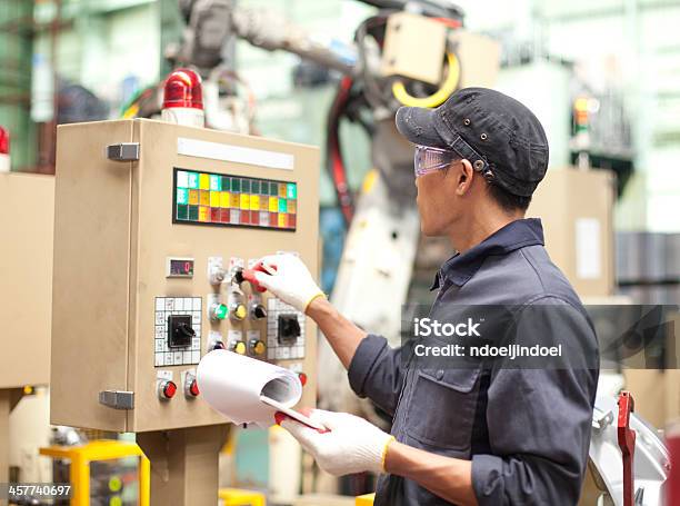 Industrial Engineer In Factory Stock Photo - Download Image Now - Machinery, Factory, Repairing