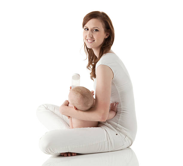 istock Happy mother feeding her baby 457749603