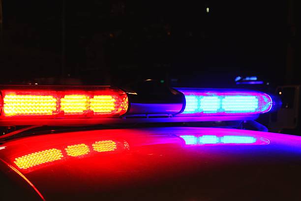 istock Lit up police car lights during nighttime 457765307