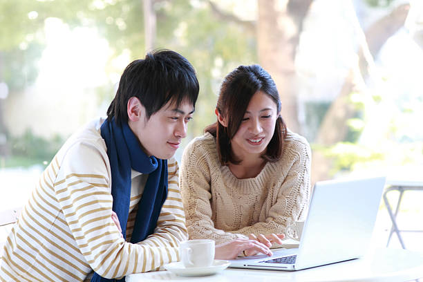 istock A young couple sitting by the ta me using a laptop 457768149