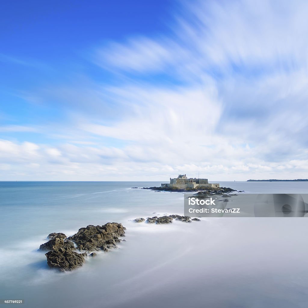 Saint Malo Fort National and rocks, high tide. Brittany, France. Saint Malo beach, Fort National and rocks during High Tide. Brittany, France, Europe. Long exposure photography Beach Stock Photo