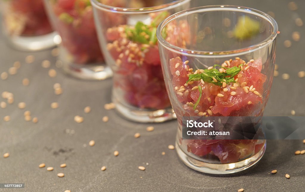 Appetizers Amuse-bouche of Tuna Tatar in glass sprinkled with roasted sesame seeds and spring onion Amuse Bouche Stock Photo