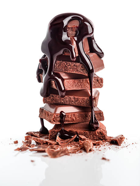 stapel chocolated syrop mit schokolade überzogene - chocolate chocolate candy dark chocolate pouring stock-fotos und bilder
