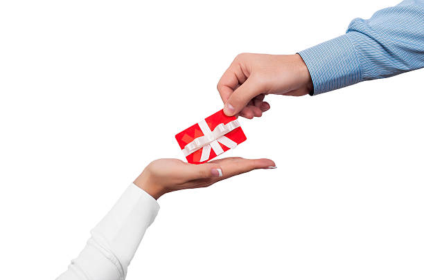 istock Person giving another person a red gift card 457778771