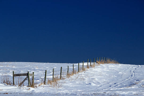 istock Wood post fence line surrounded by snow 457793951