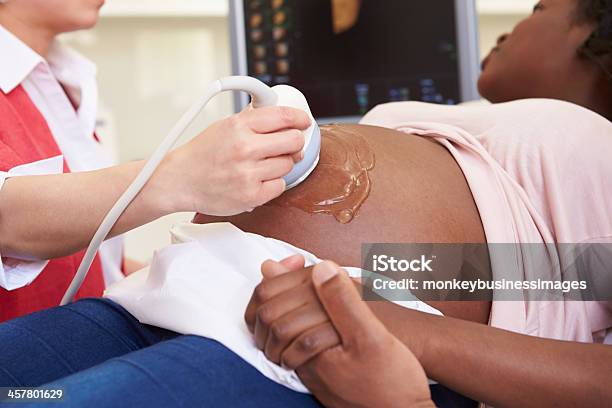 Pregnant Woman And Partner Having 4d Ultrasound Scan Stock Photo - Download Image Now